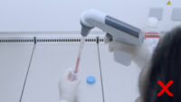 Wrong way of pipetting with serological pipette in laminar hood.