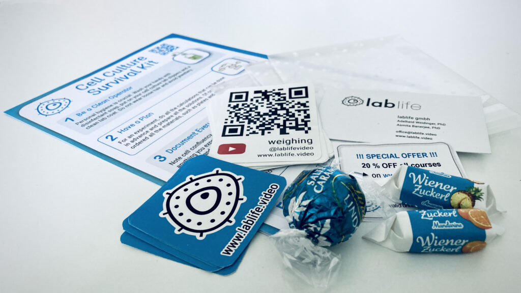 lablife goodie bag for ÖGMBT with stickers, sweets and cell culture survival kit in blue and white colours.