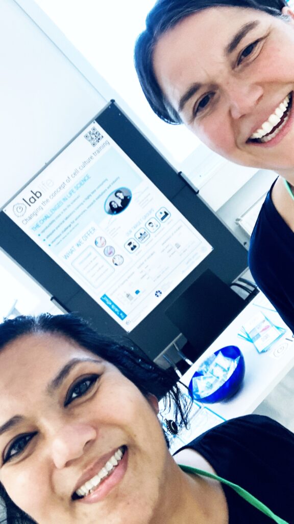 lablife team at OEGMBT Advanced cell culture workshop 2025 BOKU Vienna with goodie bags with chocolate and stickers in blue and white.